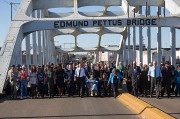 President Obama, congressman John Lewis, former President George W. Bush, and Civil Rights Movement veterans and other commemoration attendees marching across the Edmund Pettus Bridge in March, 2015